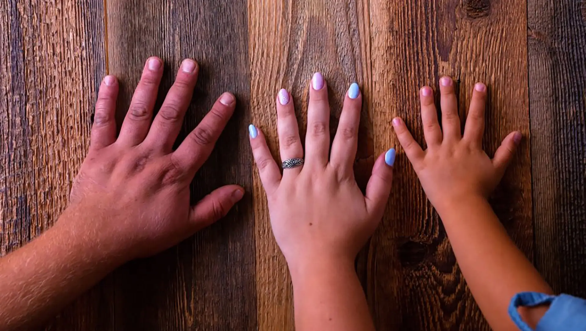 three hands on reclaimed wood